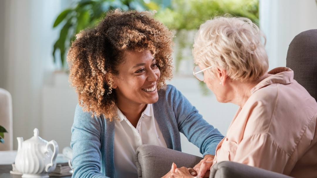 Caregiver helping a senior from All Seasons Homecare