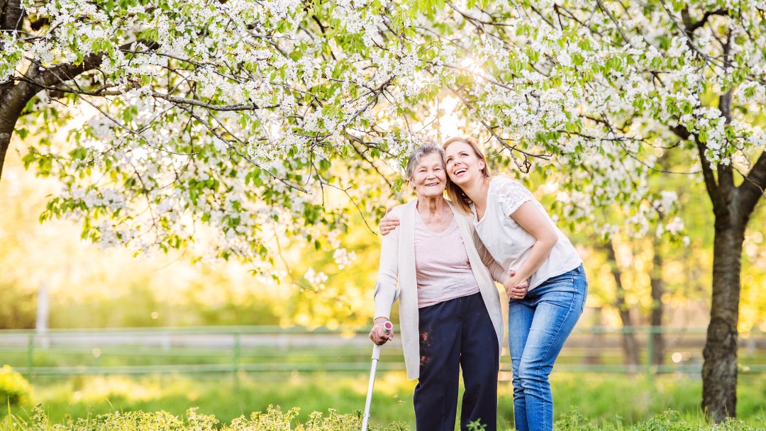 Senior and Caregiver Taking a Walk in Summertime | All Seasons Homecare